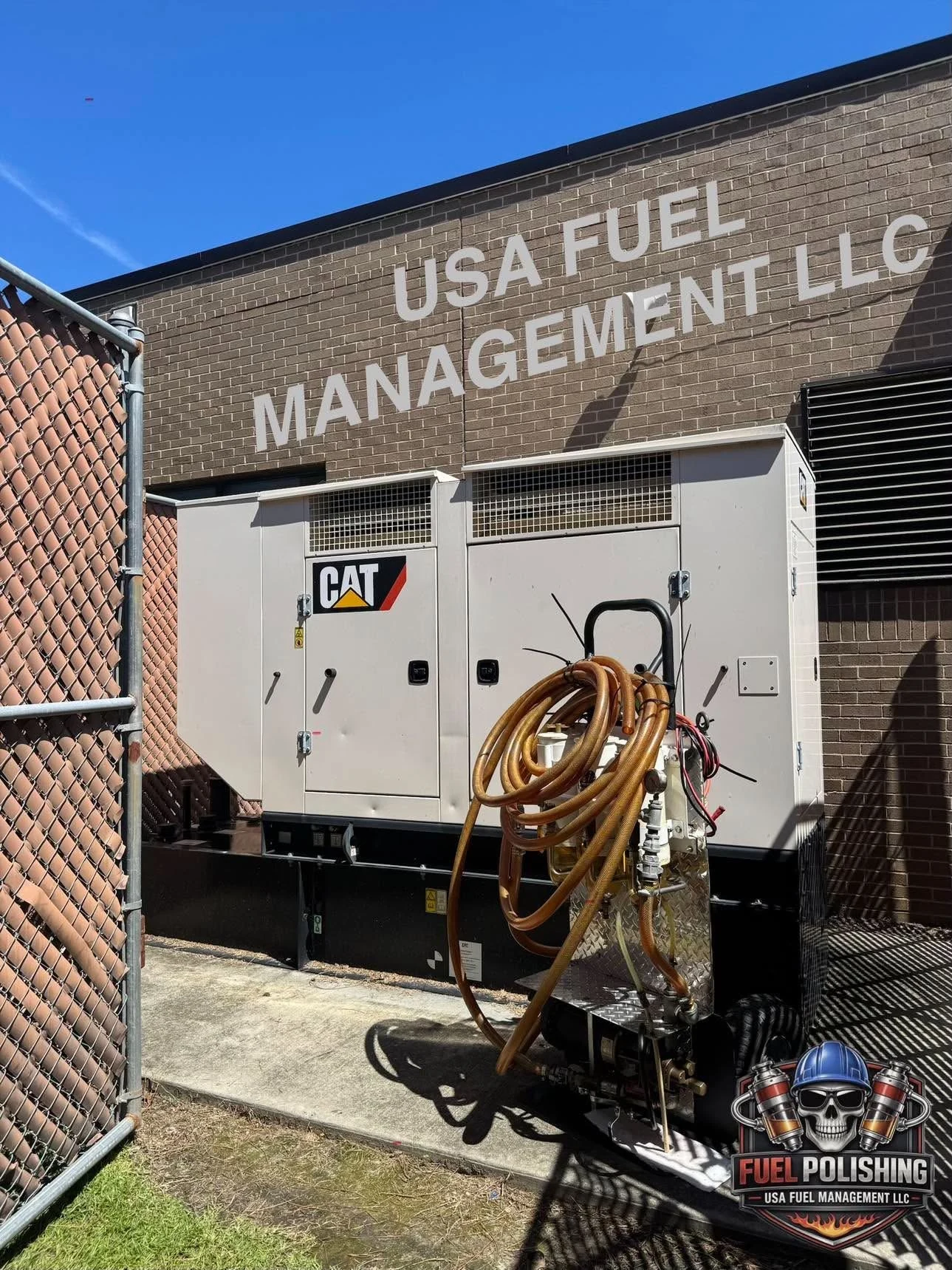 A CAT standby generator beside fuel filtration equipment and service hoses
