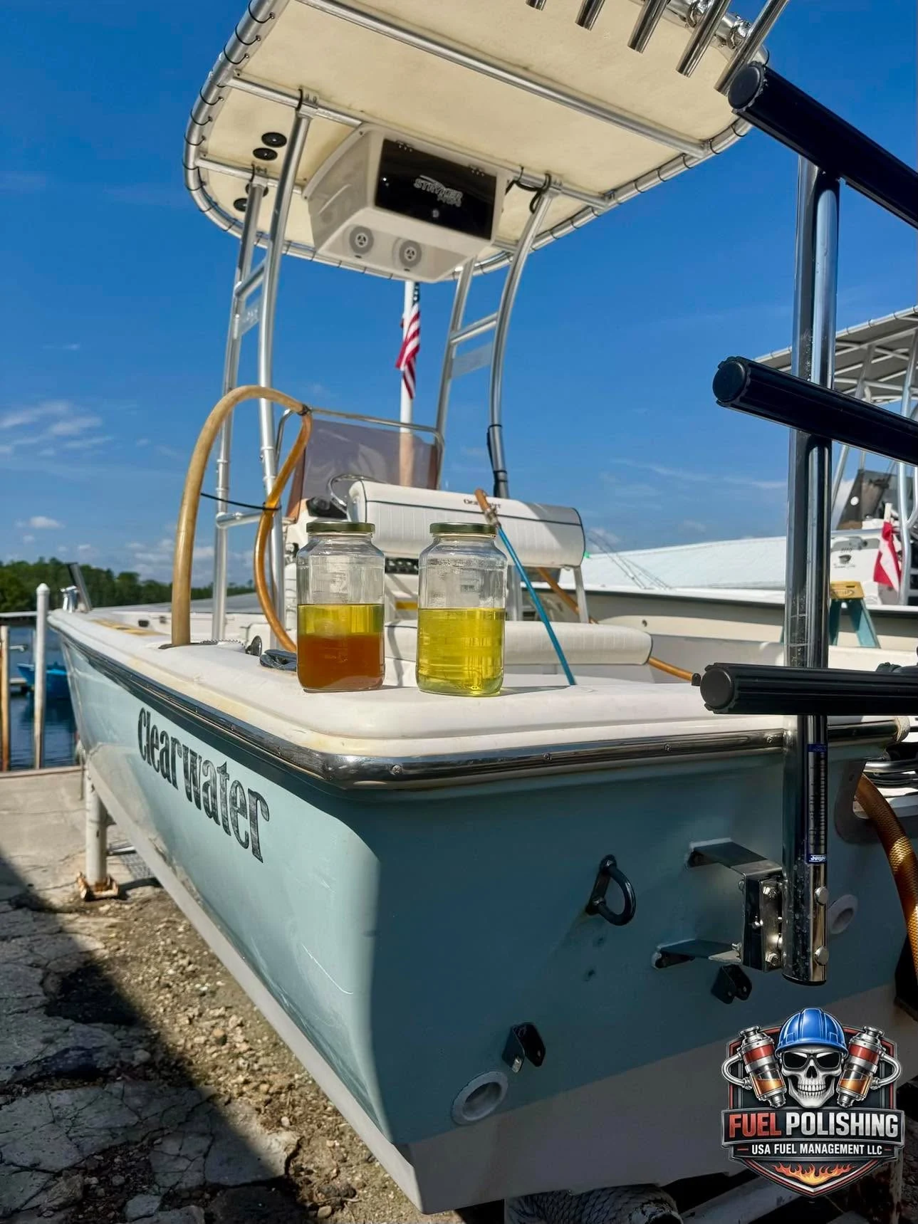Fuel service hoses and two sample jars aboard a boat at a dock