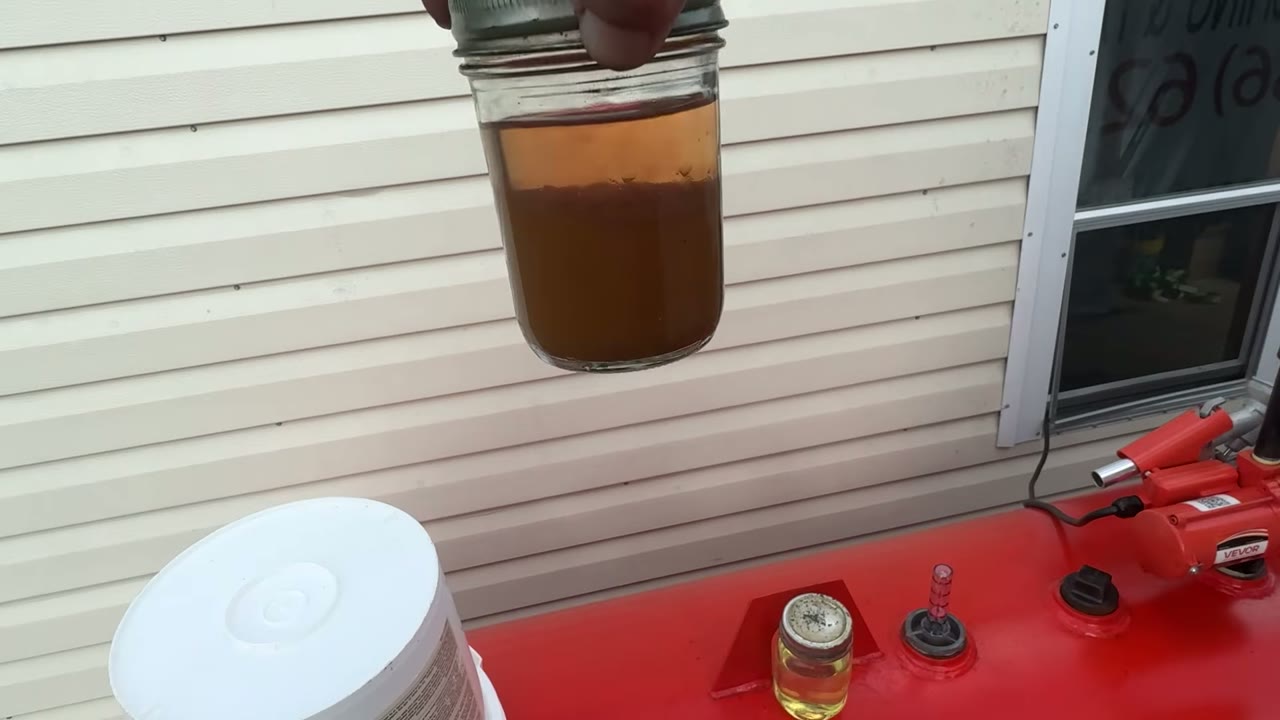 Before polishing: a fuel sample with a dark, cloudy lower layer